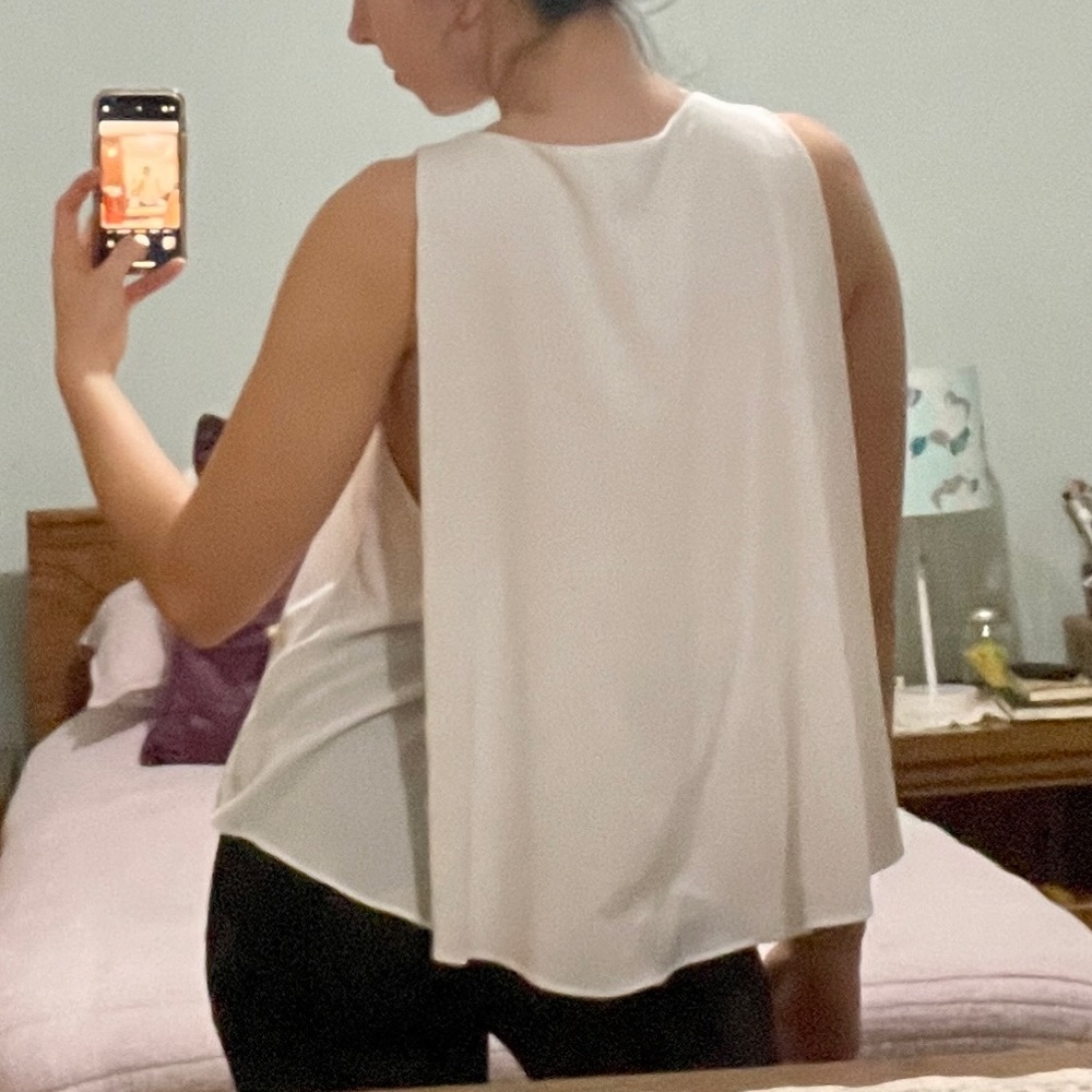 White v neck sleeveless blouse with cape draping on back